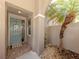 Inviting front entrance with a light blue door, tile flooring, and stone accents at 165 Tiziano Way, North Venice, FL 34275