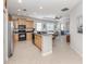 Bright kitchen boasts stainless steel appliances and flows into the living and dining areas at 165 Tiziano Way, North Venice, FL 34275