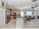 Bright kitchen boasts stainless steel appliances and flows into the living and dining areas at 165 Tiziano Way, North Venice, FL 34275