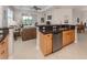Bright kitchen area featuring stainless steel appliances, a breakfast bar, and ample counter space at 165 Tiziano Way, North Venice, FL 34275