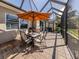 Covered patio with a table and chairs, perfect for outdoor dining and relaxation at 165 Tiziano Way, North Venice, FL 34275