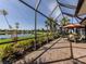 Screened lanai with a view of the lake and green space at 165 Tiziano Way, North Venice, FL 34275