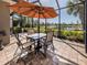 Patio with a table, chairs, and an umbrella for outdoor gatherings at 165 Tiziano Way, North Venice, FL 34275