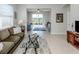 Bright living room with large windows, stylish furnishings, and views of the outdoors at 165 Tiziano Way, North Venice, FL 34275