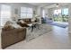 Inviting living room with large windows and access to an outdoor area overlooking the water at 165 Tiziano Way, North Venice, FL 34275