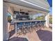 The outdoor bar features a counter with high-top seating and TV screens at 165 Tiziano Way, North Venice, FL 34275