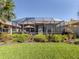 A beautiful screened patio offering a serene outdoor living space with lush landscaping and a sunny view at 165 Tiziano Way, North Venice, FL 34275