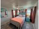 Bright bedroom with a fan, wood-look floors, and colorful furnishings and decor at 202 Mantua Dr, Venice, FL 34285