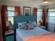 Bedroom with a fan, wood-look floors, and colorful furnishings and decor at 202 Mantua Dr, Venice, FL 34285