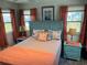 Bedroom with a fan, wood-look floors, and colorful furnishings and decor at 202 Mantua Dr, Venice, FL 34285