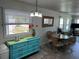 Cozy dining area with stylish blue accents, a round table, and ample natural light at 202 Mantua Dr, Venice, FL 34285