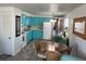Inviting kitchen featuring stylish blue cabinetry, a cozy dining area, and modern appliances at 202 Mantua Dr, Venice, FL 34285