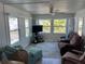 Inviting living room with lots of natural light, comfortable seating, and a ceiling fan at 202 Mantua Dr, Venice, FL 34285