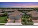 Beautiful lakefront home featuring a tile roof and well-manicured landscaping at 21649 Avon Park Ct, Venice, FL 34293