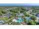 Aerial view of the community, highlighting the clubhouse, pools, lush landscaping, and surrounding residential area at 21649 Avon Park Ct, Venice, FL 34293