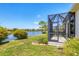 Beautiful backyard featuring a screened-in lanai overlooking a peaceful lake, set in manicured grounds at 21649 Avon Park Ct, Venice, FL 34293