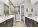 Beautiful bathroom with double vanity sinks, a tile shower, and stylish fixtures at 21649 Avon Park Ct, Venice, FL 34293