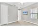 Neutral bedroom features carpet floors, window with blinds, ceiling fan, and closet for storage at 21649 Avon Park Ct, Venice, FL 34293