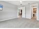 Spacious primary bedroom featuring neutral paint, plush carpeting, and an open doorway to the en-suite bathroom at 21649 Avon Park Ct, Venice, FL 34293