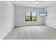Neutral primary bedroom features soft carpeting, ample natural light, and a ceiling fan at 21649 Avon Park Ct, Venice, FL 34293