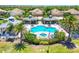 Inviting community pool and jacuzzi area with shade cabanas, surrounded by green lawns and palm trees at 21649 Avon Park Ct, Venice, FL 34293