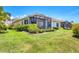 Well-maintained home featuring a screened-in lanai overlooking a lush backyard, set in a charming community at 21649 Avon Park Ct, Venice, FL 34293