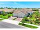 Charming home featuring a tile roof, lush landscaping, and a three-car garage at 21649 Avon Park Ct, Venice, FL 34293