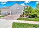 Close-up of a home showcasing a three-car garage and manicured lawn at 21649 Avon Park Ct, Venice, FL 34293