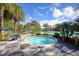 Relaxing hot tub with surrounding patio, landscaping, and community pool views at 21649 Avon Park Ct, Venice, FL 34293