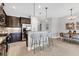 Modern kitchen boasts granite countertops, stainless steel appliances, and a stylish breakfast bar area at 21649 Avon Park Ct, Venice, FL 34293