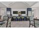 Modern kitchen with island, breakfast bar, stainless steel appliances and flat screen televisions at 21649 Avon Park Ct, Venice, FL 34293