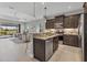 Well-appointed kitchen with views of the adjacent living room and lanai showcasing the open floor plan at 21649 Avon Park Ct, Venice, FL 34293