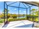 Enjoy breathtaking lake views from this screened lanai with lush landscaping surrounding the serene lake at 21649 Avon Park Ct, Venice, FL 34293