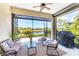 Relaxing screened lanai with comfortable seating, BBQ grill, and beautiful lake views at 21649 Avon Park Ct, Venice, FL 34293