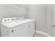 Functional laundry room with a white Whirlpool washer and dryer set and tiled floors at 21649 Avon Park Ct, Venice, FL 34293