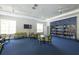 Spacious library area with bookshelves, tables, chairs, and bright natural light at 21649 Avon Park Ct, Venice, FL 34293