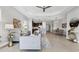 Open-concept living area showcases elegant decor, tile flooring, and seamless flow to the modern kitchen and dining area at 21649 Avon Park Ct, Venice, FL 34293