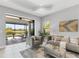 Comfortable living room with a screened-in patio, neutral tones, and elegant decor at 21649 Avon Park Ct, Venice, FL 34293
