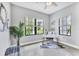 Light-filled office space with two windows with blinds, a desk, stylish decor, and tile floors at 21649 Avon Park Ct, Venice, FL 34293