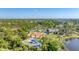 Aerial view of community park with playground, picnic pavilions, and lake, offering residents recreational options at 21649 Avon Park Ct, Venice, FL 34293