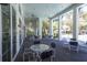 Relaxing covered patio with outdoor seating and views of tropical landscaping at 21649 Avon Park Ct, Venice, FL 34293