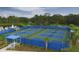 Aerial view of community pickleball courts surrounded by a blue fence at 21649 Avon Park Ct, Venice, FL 34293