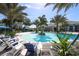 Stunning community pool with plenty of seating areas and lush landscaping at 21649 Avon Park Ct, Venice, FL 34293