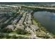 Aerial view of a community with lake, lush greenery, and convenient parking at 233 Cape Harbour Loop # 107, Bradenton, FL 34212