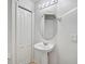Clean pedestal sink with overhead lighting in a well-maintained bathroom at 233 Cape Harbour Loop # 107, Bradenton, FL 34212