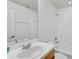 Well-lit bathroom featuring a shower-tub combo, white tile, and a vanity at 233 Cape Harbour Loop # 107, Bradenton, FL 34212
