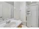 Bright bathroom featuring a vanity and a tiled walk-in shower with a glass door at 233 Cape Harbour Loop # 107, Bradenton, FL 34212