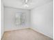 Clean, neutral bedroom with carpet flooring and a window, ready for personalization at 233 Cape Harbour Loop # 107, Bradenton, FL 34212