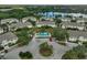 Aerial view showcasing the community pool, surrounding townhomes, and lush landscaping at 233 Cape Harbour Loop # 107, Bradenton, FL 34212