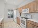 Bright kitchen with white appliances, and wooden cabinets at 233 Cape Harbour Loop # 107, Bradenton, FL 34212